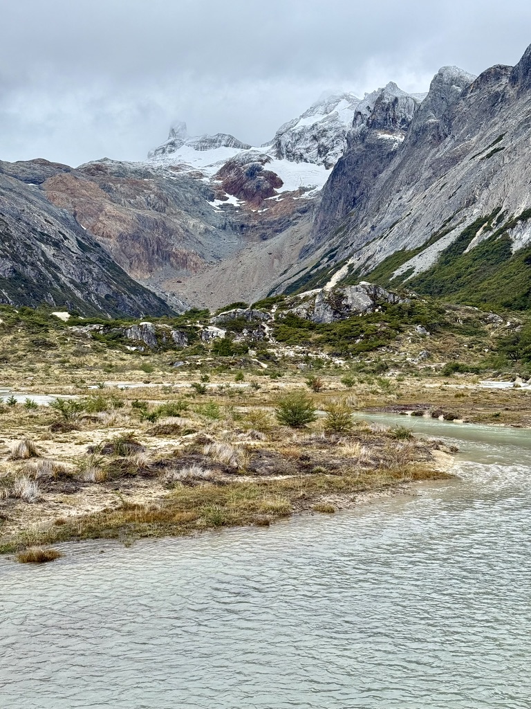 Laguna Esmeralda’s milky turquoise water below snow-dusted peaks and the Ojo del Albino glacier