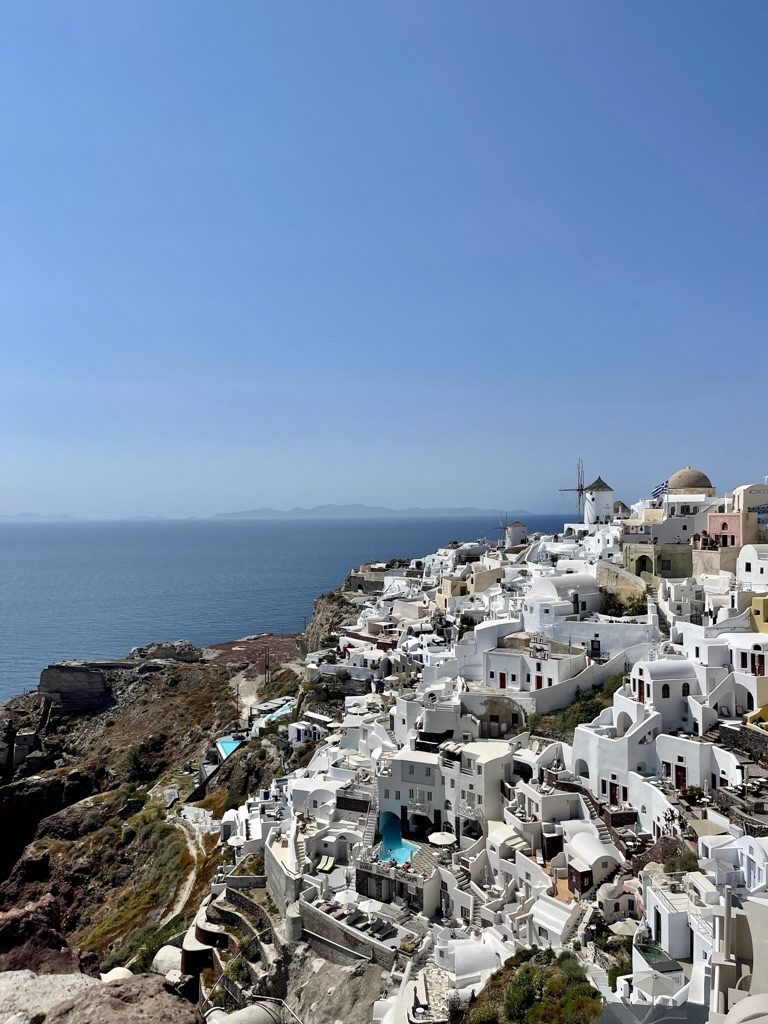 White houses and windmills of Oia on the cliff edge